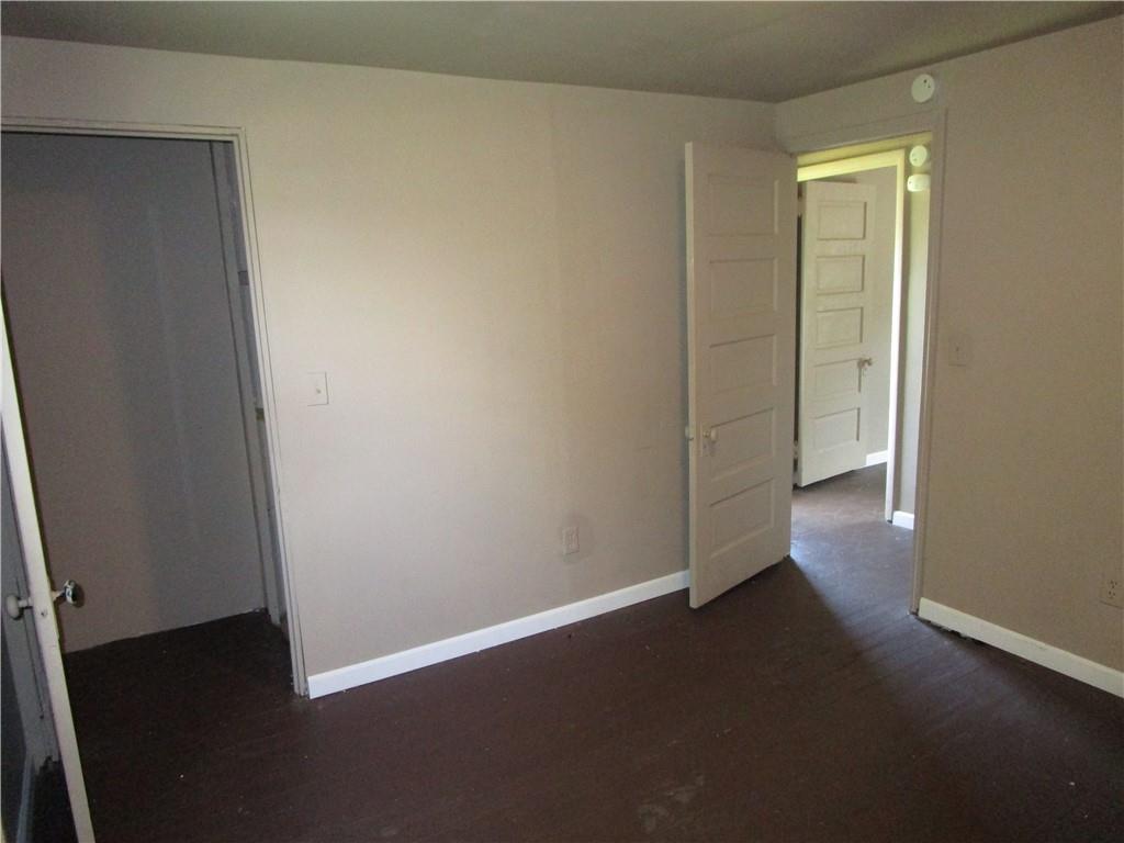 1124 Webster Street Farrell, PA 16121 - Photo 13 of 17 an empty room with wooden floor and windows