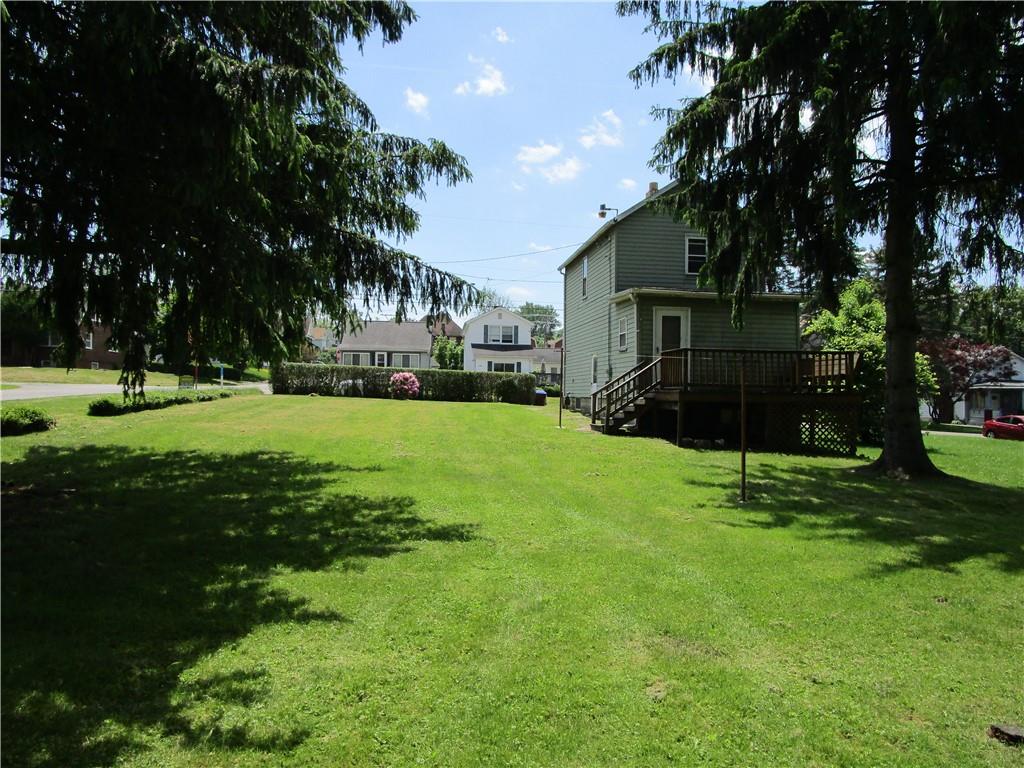 1124 Webster Street Farrell, PA 16121 - Photo 16 of 17 a view of a house with a big yard and large trees