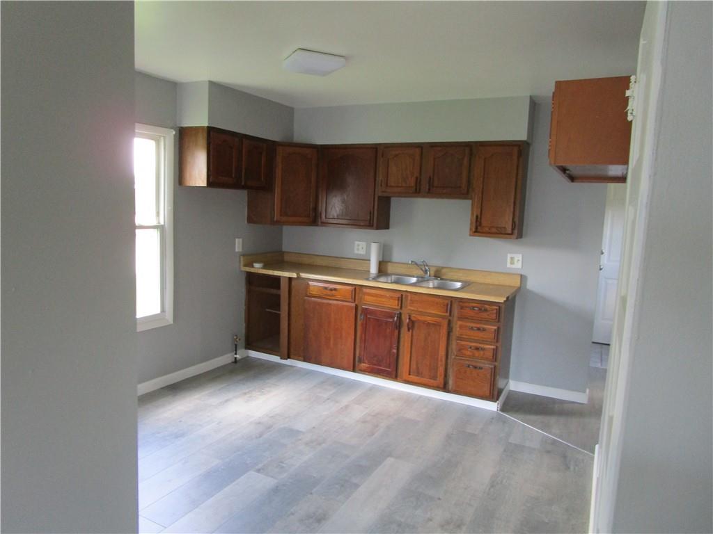1124 Webster Street Farrell, PA 16121 - Photo 7 of 17 a kitchen with stainless steel appliances a sink stove and cabinets