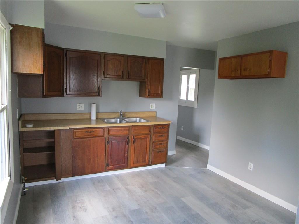 1124 Webster Street Farrell, PA 16121 - Photo 8 of 17 a kitchen with stainless steel appliances granite countertop a stove a sink and a refrigerator