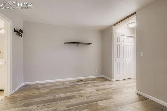 a view of a room with wooden floor and bathroom