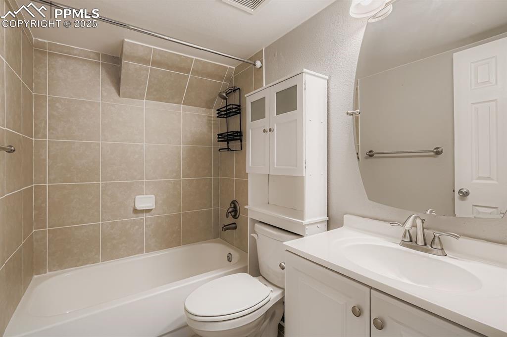 Undisclosed Address Colorado Springs, CO 80917 - Photo 7 of 11 a bathroom with a bathtub shower sink vanity mirror and toilet