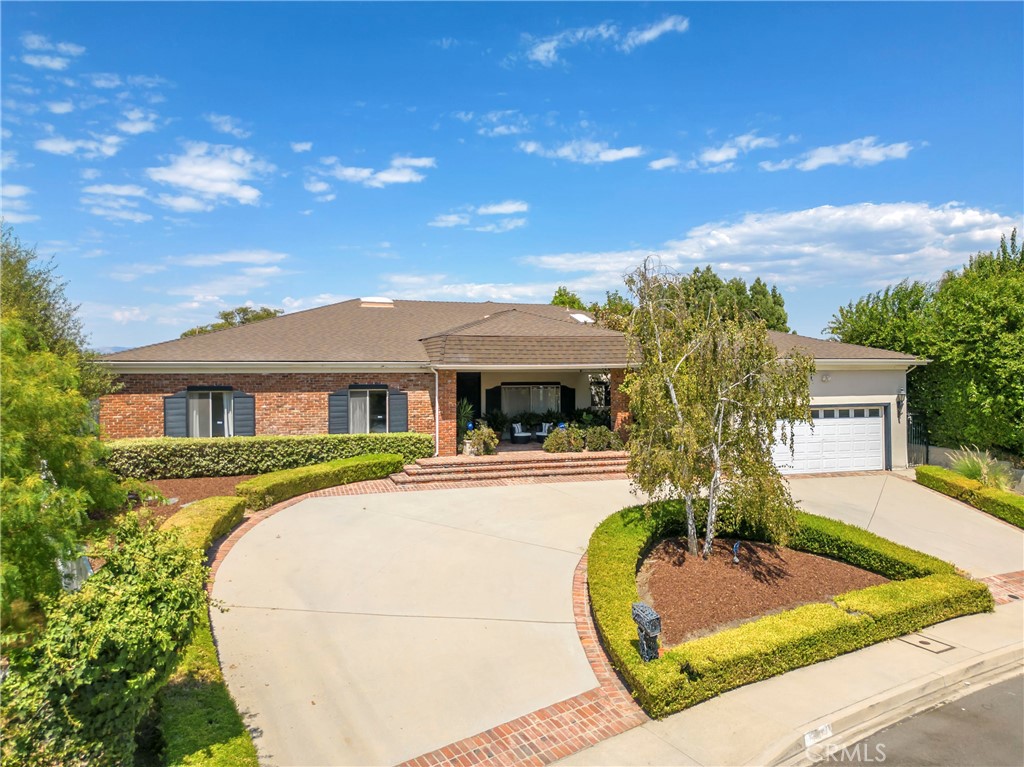 16355 Tudor Drive Encino, CA 91436 - Photo 1 of 51 a front view of a house with a garden