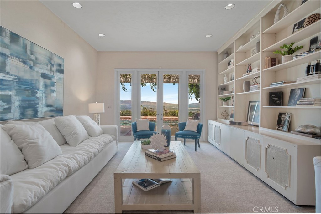16355 Tudor Drive Encino, CA 91436 - Photo 12 of 51 a living room with furniture a rug and white walls