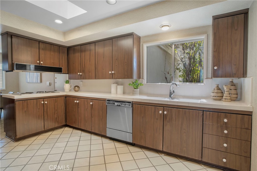16355 Tudor Drive Encino, CA 91436 - Photo 14 of 51 a kitchen with a sink cabinets and window