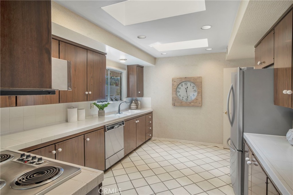 16355 Tudor Drive Encino, CA 91436 - Photo 16 of 51 a spacious bathroom with a sink a mirror and a shower