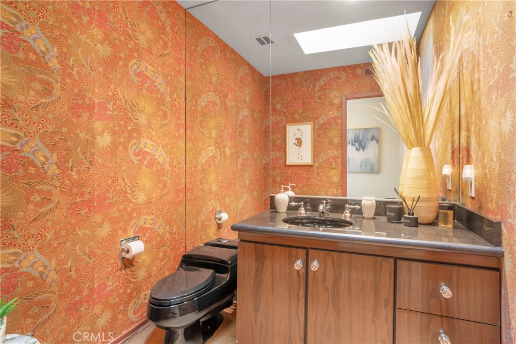 16355 Tudor Drive Encino, CA 91436 - Photo 18 of 51 a bathroom with a sink a toilet and a mirror