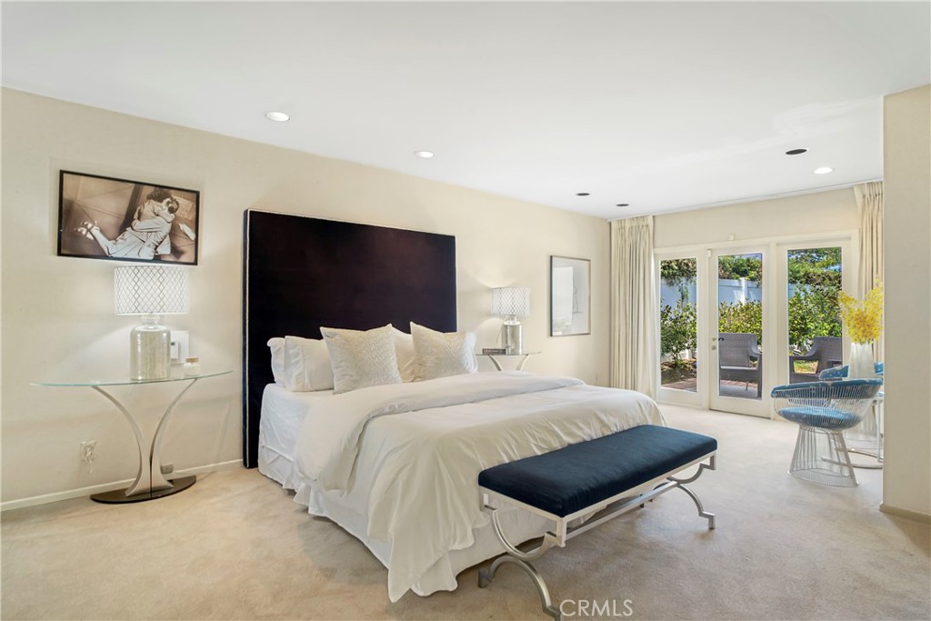 16355 Tudor Drive Encino, CA 91436 - Photo 19 of 51 a bedroom with a bed and large window