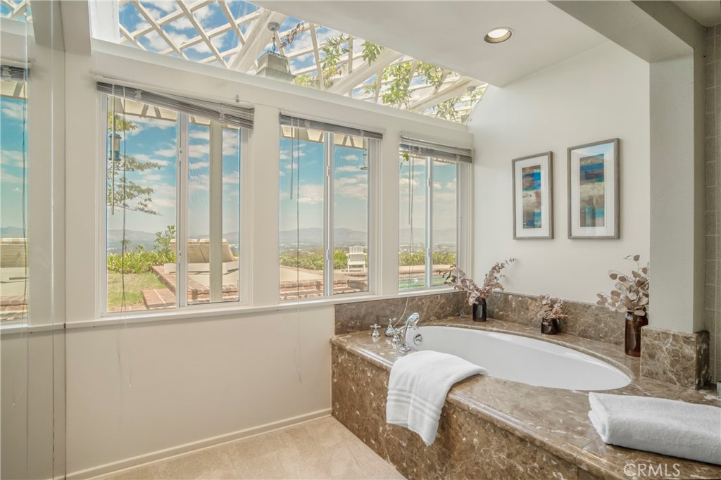 16355 Tudor Drive Encino, CA 91436 - Photo 24 of 51 a bathroom with a granite countertop sink and a large mirror