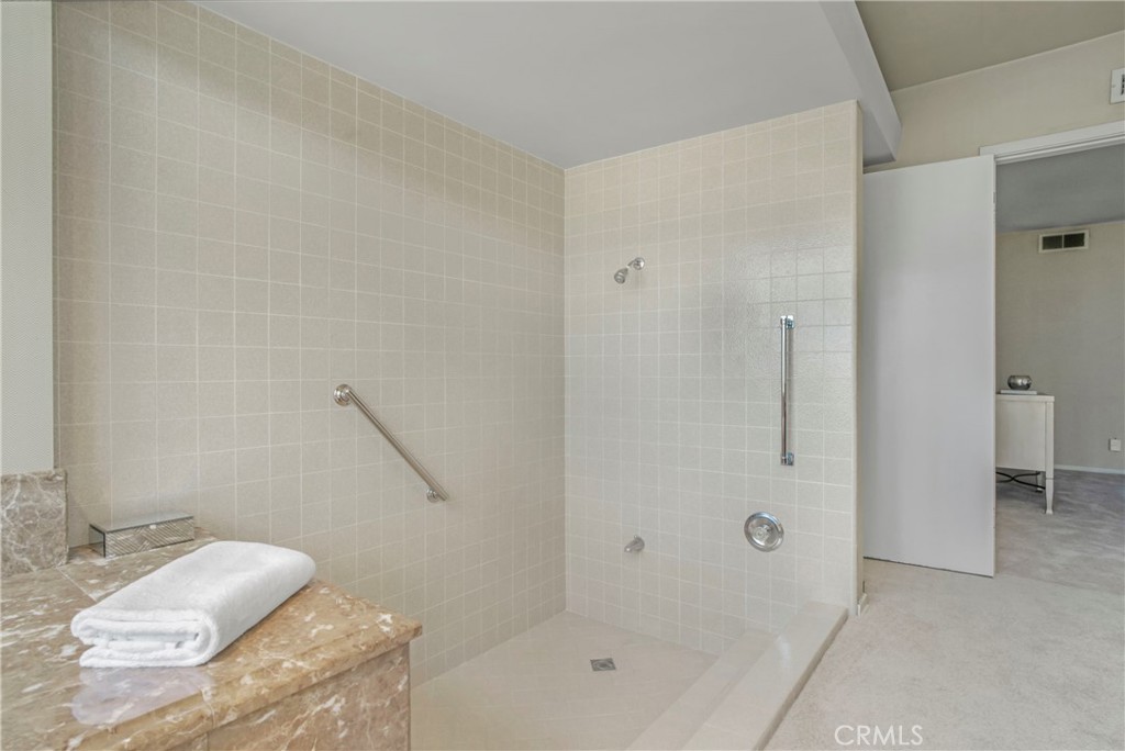 16355 Tudor Drive Encino, CA 91436 - Photo 25 of 51 a bathroom with a bathtub and shower