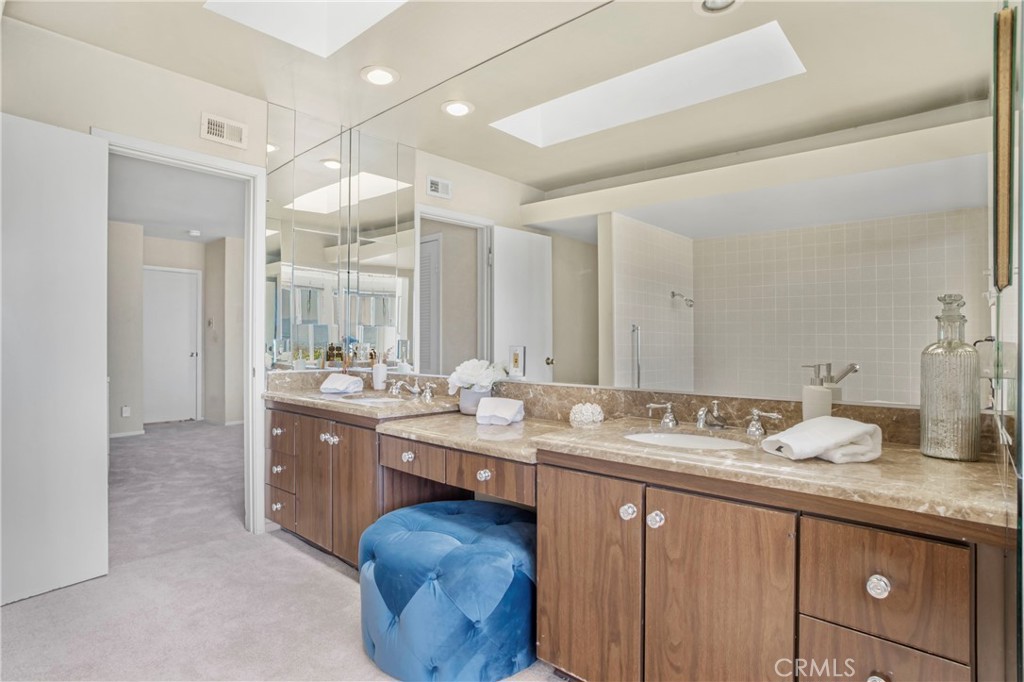 16355 Tudor Drive Encino, CA 91436 - Photo 26 of 51 a bathroom with a granite countertop sink mirror and double