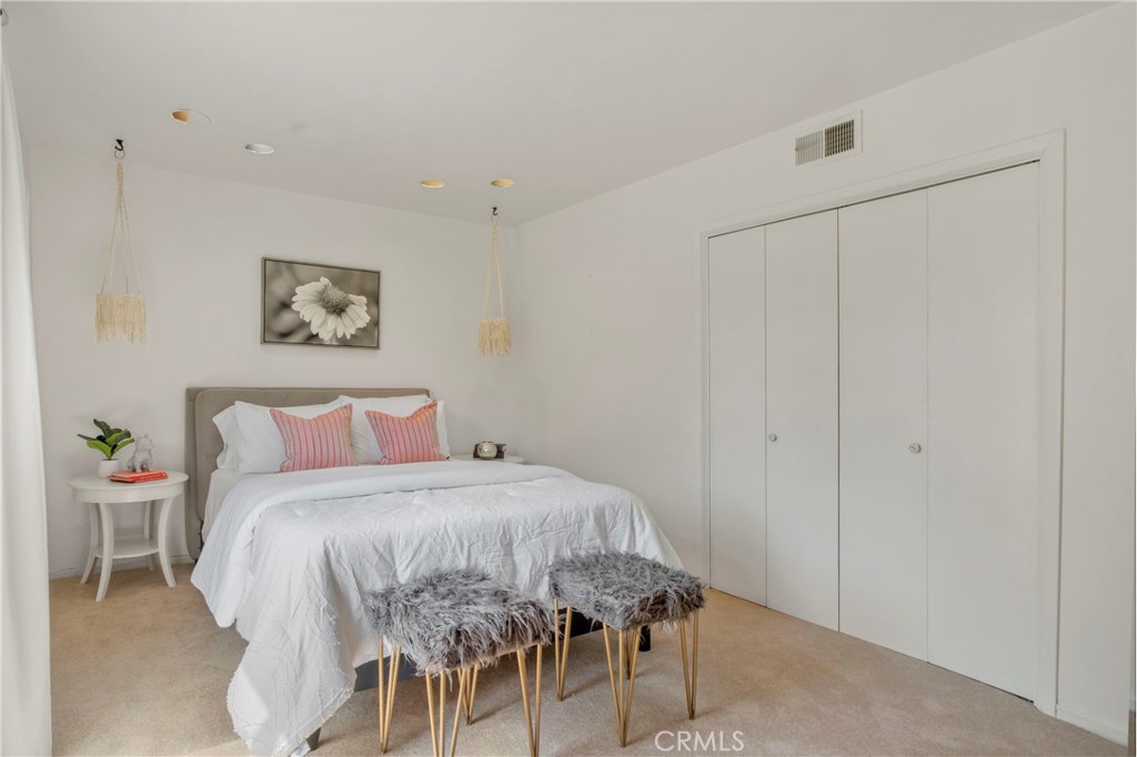 16355 Tudor Drive Encino, CA 91436 - Photo 30 of 51 a bedroom with a bed and a table in it