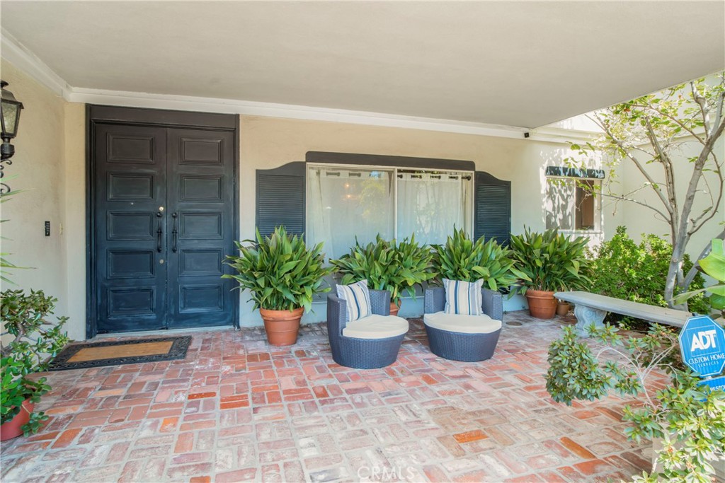 16355 Tudor Drive Encino, CA 91436 - Photo 3 of 51 a view of a house with potted plants and more potted plants