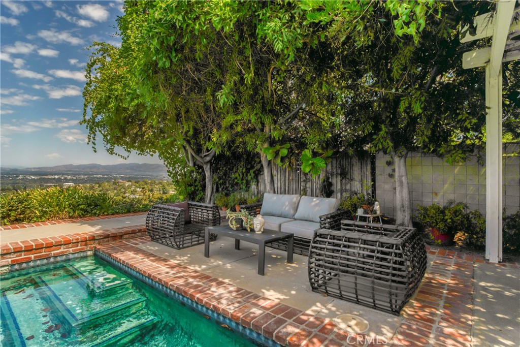 16355 Tudor Drive Encino, CA 91436 - Photo 39 of 51 a view of a patio with couches table and chairs and potted plants
