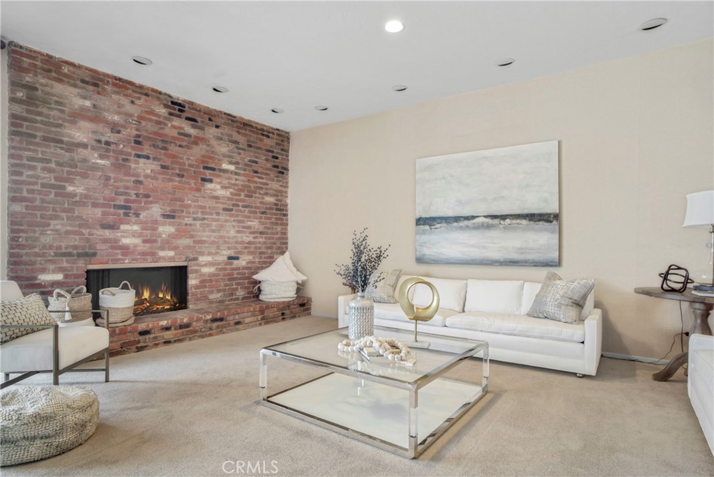 16355 Tudor Drive Encino, CA 91436 - Photo 8 of 51 a living room with furniture a fireplace and a table