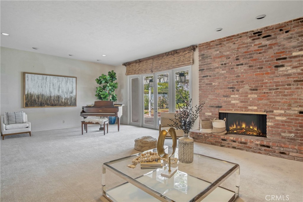16355 Tudor Drive Encino, CA 91436 - Photo 10 of 51 a living room with furniture and a fireplace