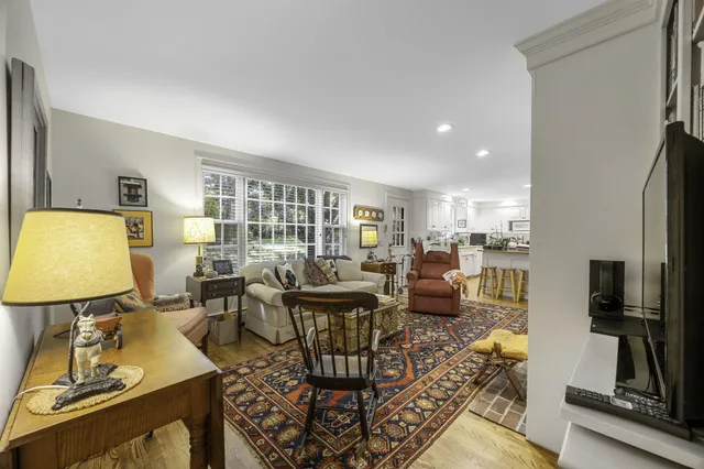 a living room with fireplace furniture and a flat screen tv