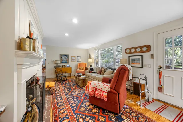 a living room with furniture a fireplace and a window