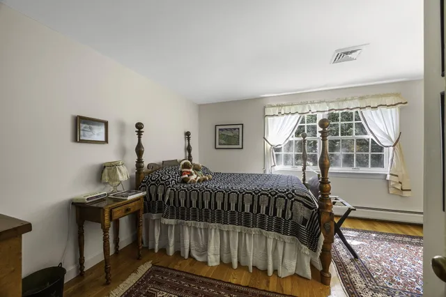 a bed sitting in a bedroom next to a window