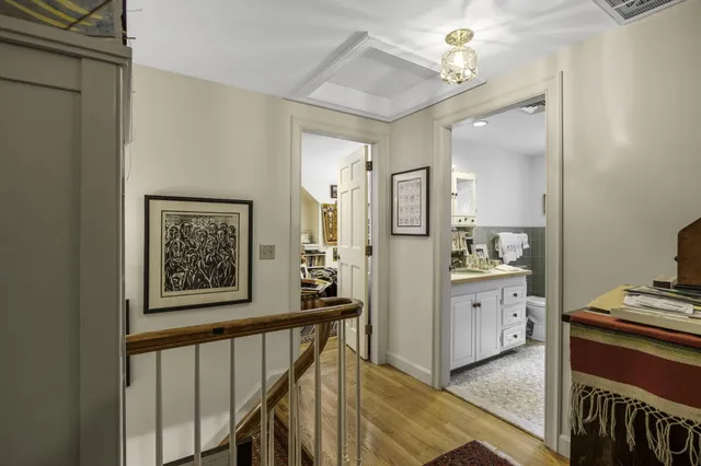 a view of a hallway with workspace and a window