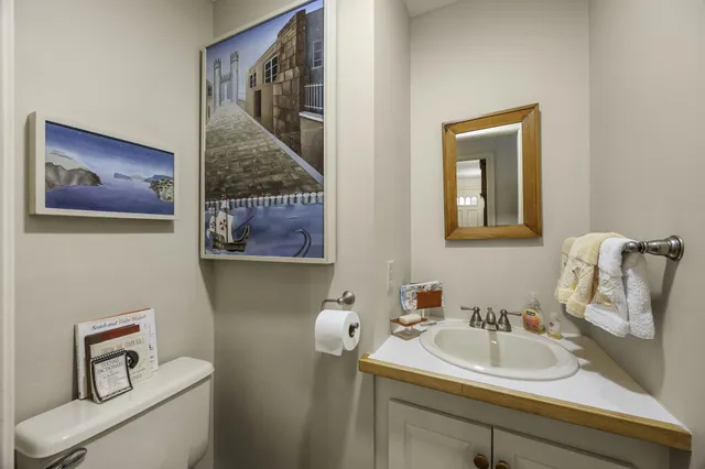 a bathroom with a sink and mirror with toilet