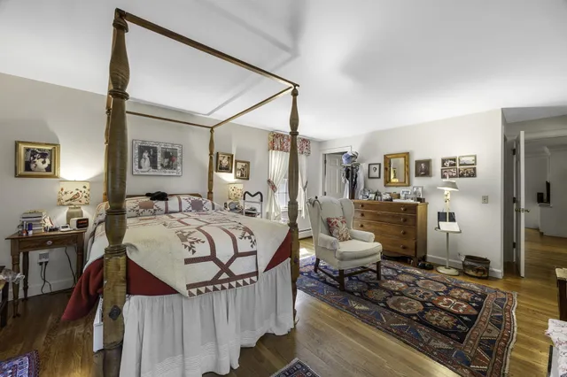 a bedroom with furniture and a rug