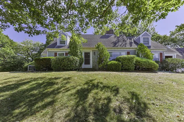 a front view of a house with a garden