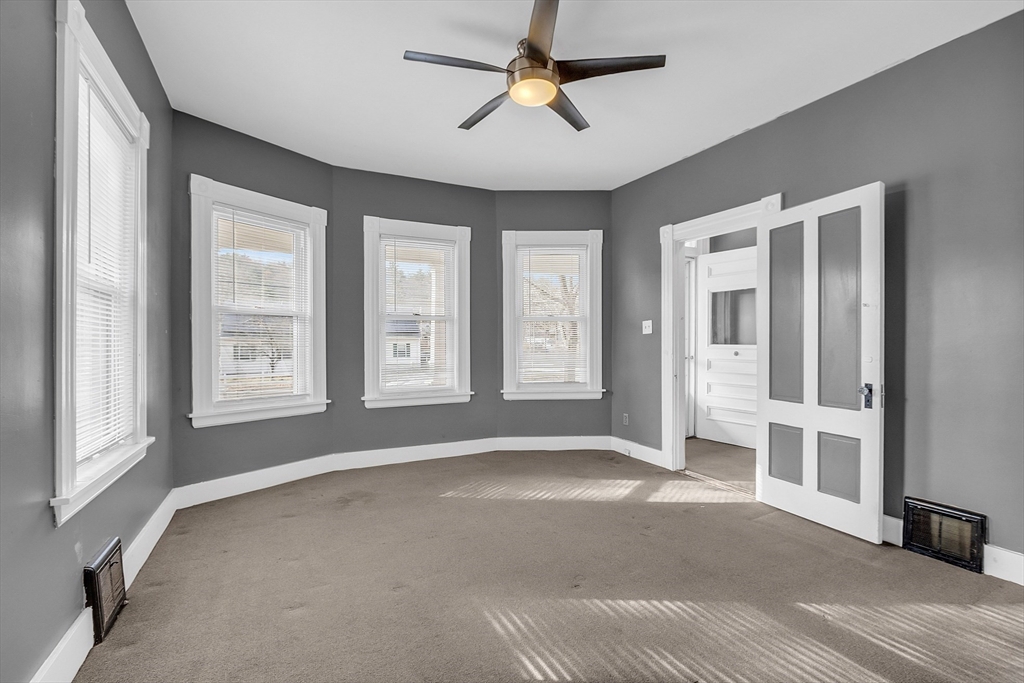24 Lancaster Road Shirley, MA 01464 - Photo 18 of 35 a view of an empty room with a window and a kitchen