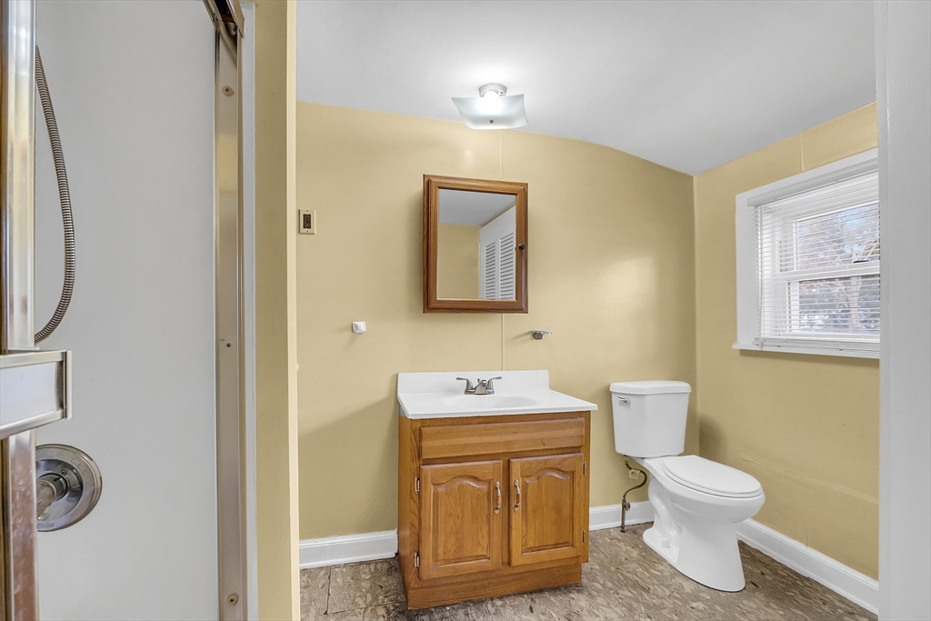 24 Lancaster Road Shirley, MA 01464 - Photo 27 of 35 a bathroom with a toilet sink vanity and mirror