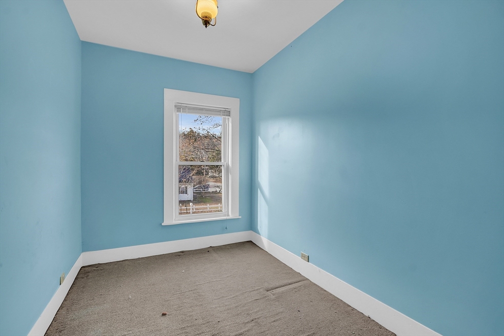 24 Lancaster Road Shirley, MA 01464 - Photo 31 of 35 an empty room with windows and mirror