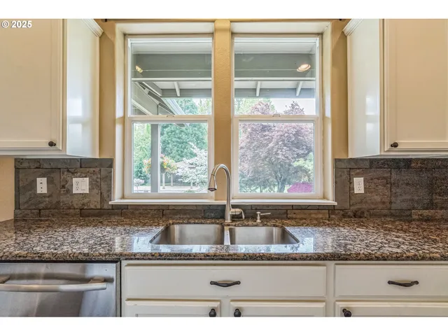a kitchen with granite countertop a sink and a counter top space
