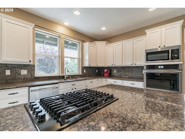 a kitchen with wooden cabinets and a stove top oven