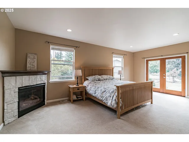 a spacious bedroom with a bed and a fireplace