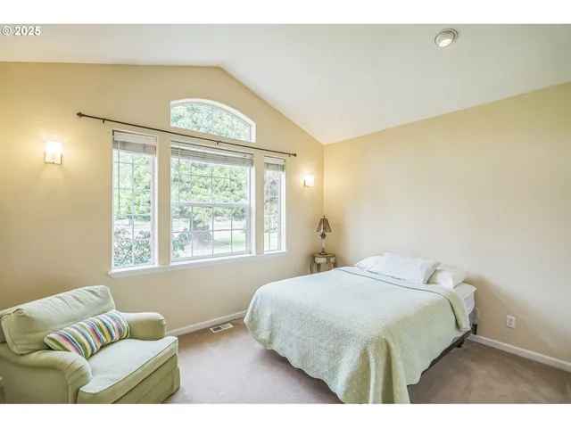 a bedroom with a bed and a couch