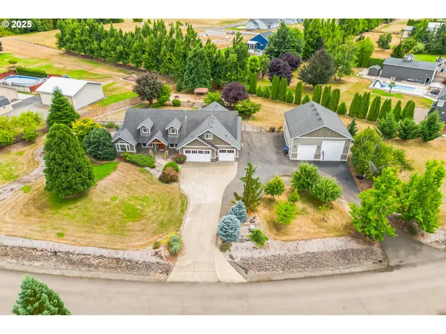 an aerial view of a house with a swimming pool