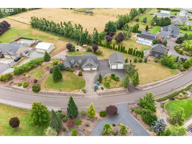 an aerial view of residential houses with outdoor space and ocean view