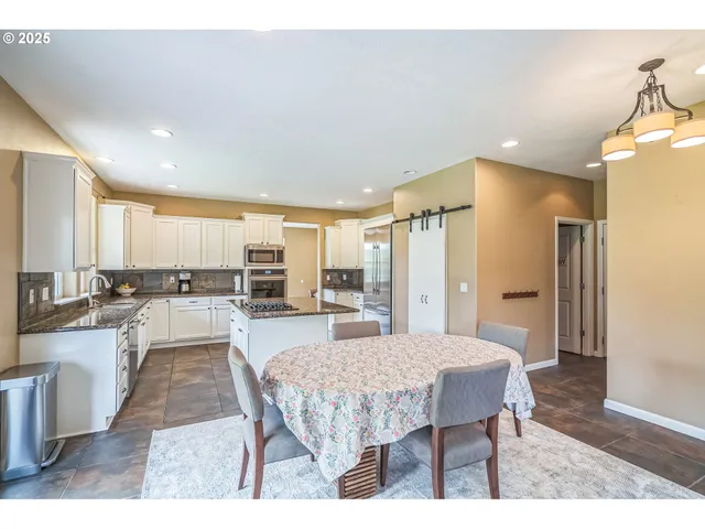 a view of a dining room kitchen counter space and stainless steel appliances