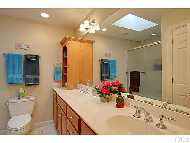 4701 Stiller Street Raleigh, NC 27609 - Photo 18 of 25 a bathroom with a sink vanity and a mirror