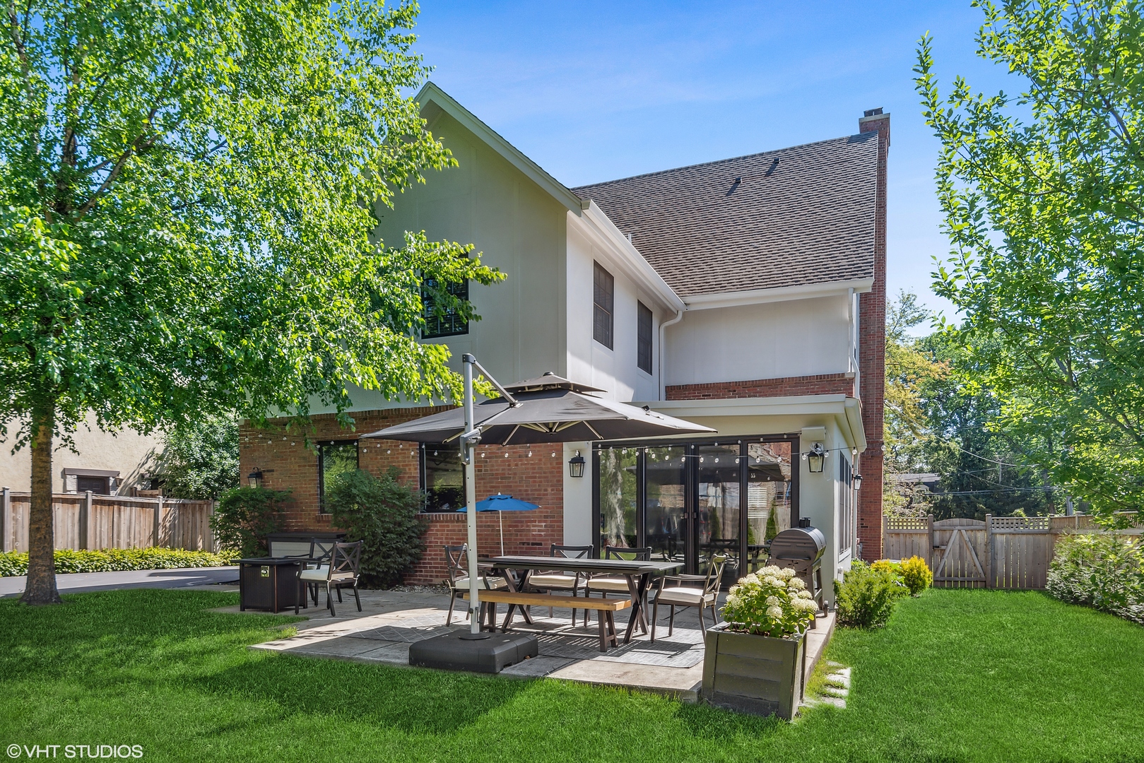 60 Sheridan Road Highland Park, IL 60035 - Photo 2 of 30 a patio with table and chairs with plants and wooden fence
