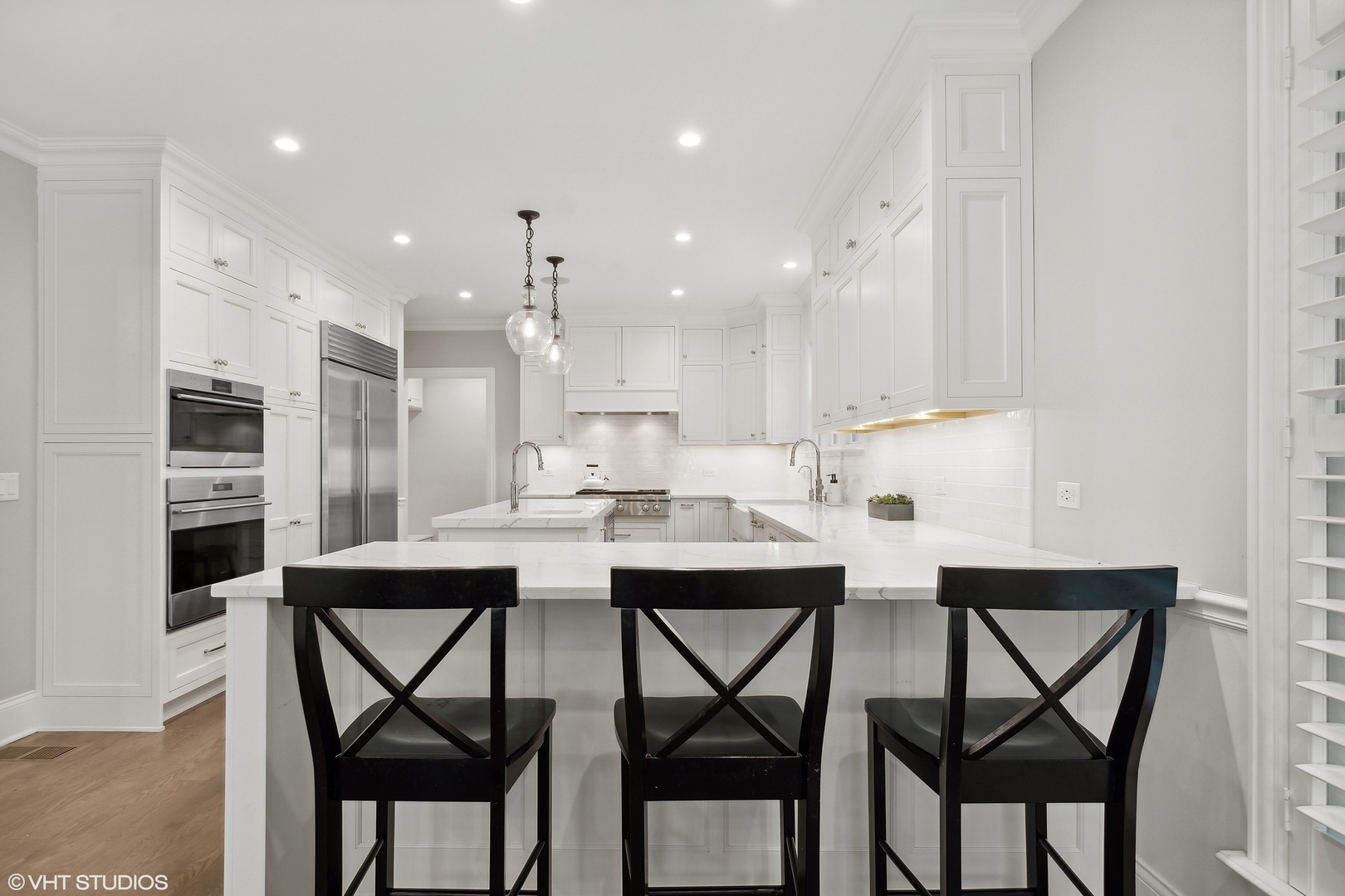 60 Sheridan Road Highland Park, IL 60035 - Photo 7 of 30 a kitchen with stainless steel appliances kitchen island granite countertop a dining table chairs and white cabinets