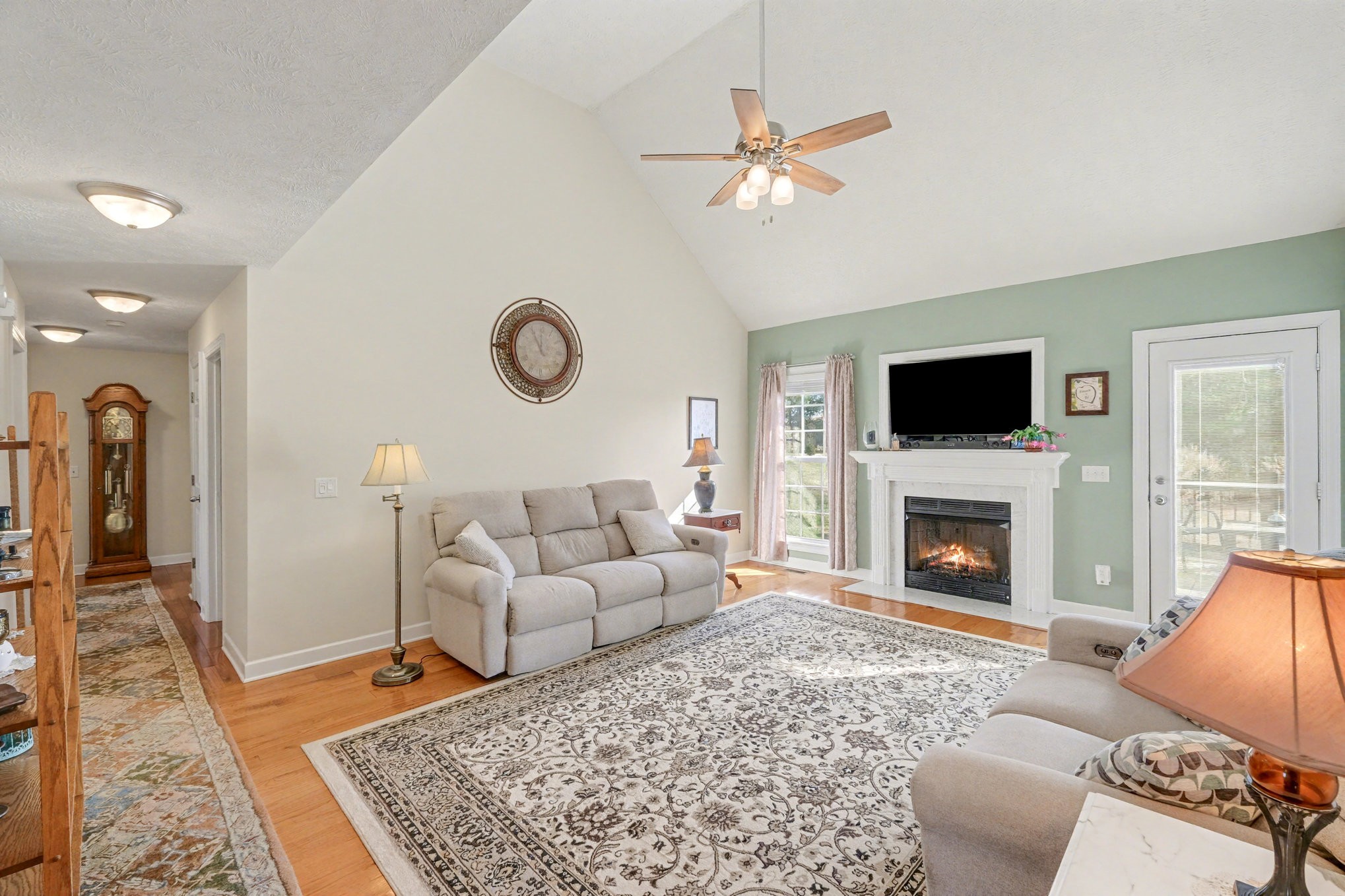 1002 Roland Court Cottontown, TN 37048 - Photo 12 of 41 a living room with furniture a rug and a fireplace