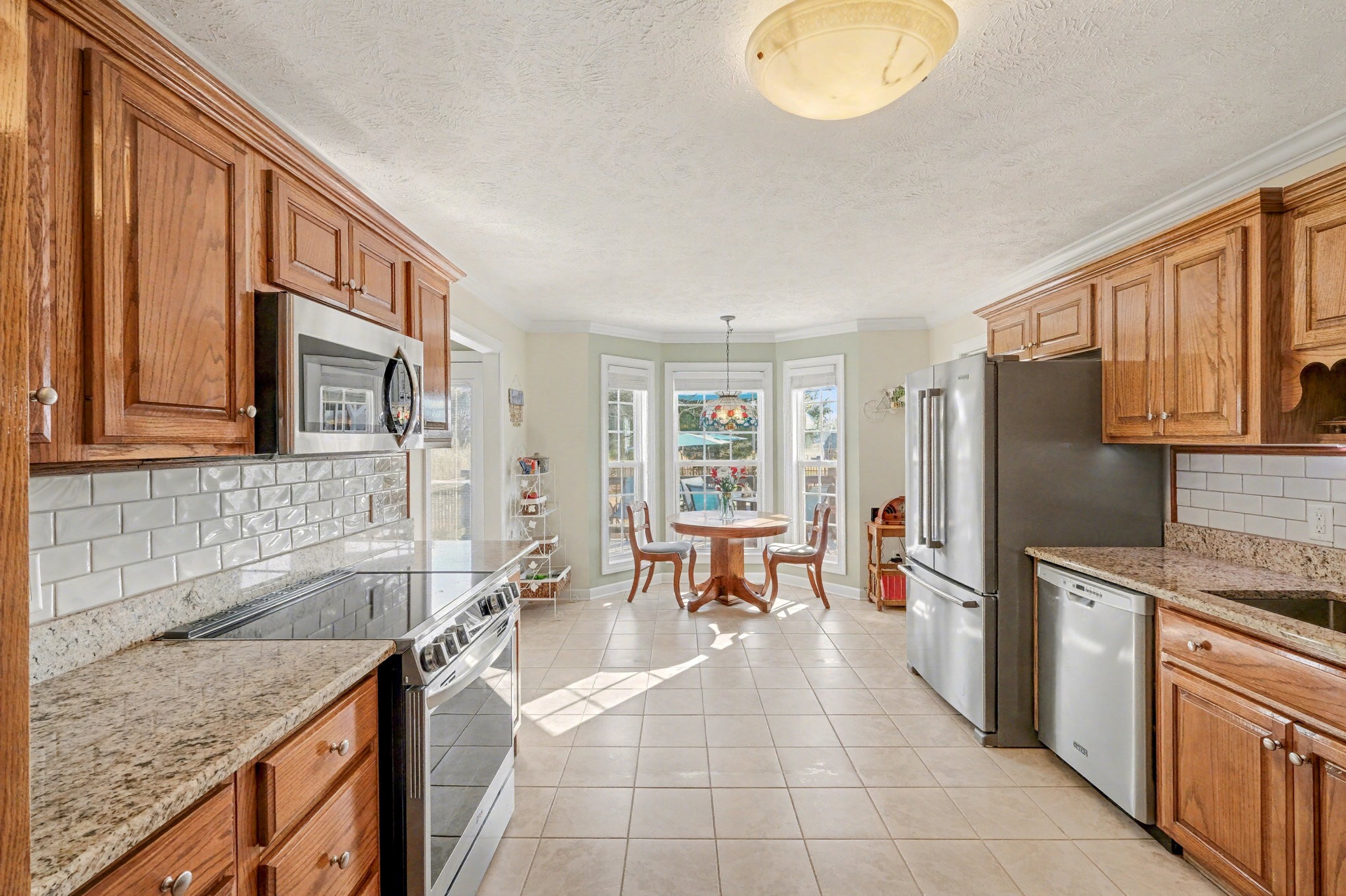 1002 Roland Court Cottontown, TN 37048 - Photo 19 of 41 a kitchen with stainless steel appliances granite countertop a sink stove and refrigerator