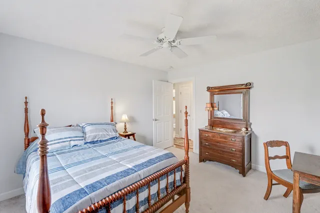 a bedroom with a bed table and chair