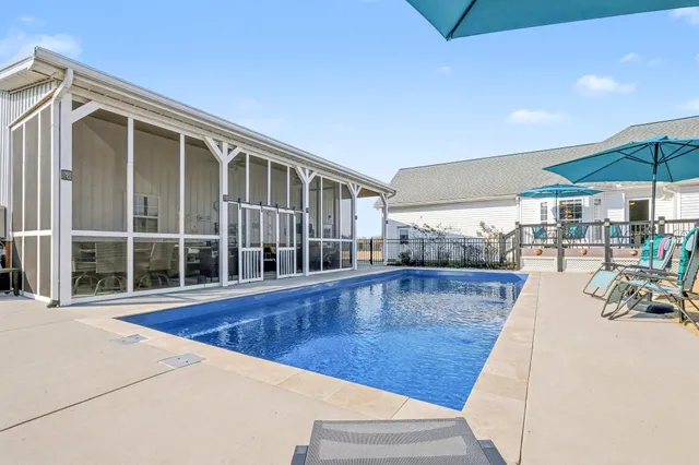 a view of a patio with a table and chairs under an umbrella