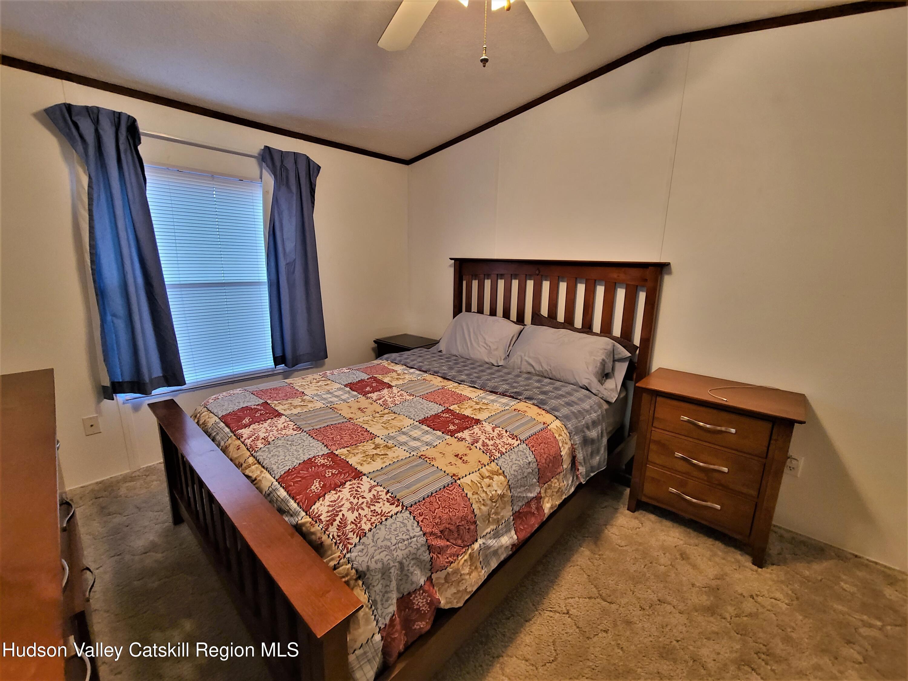 25 George Segar Road Bethel, NY 12783 - Photo 13 of 28 a bedroom with a bed and window