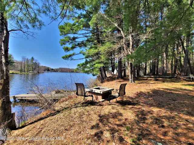 a view of a backyard with table and chairs and a fire pit