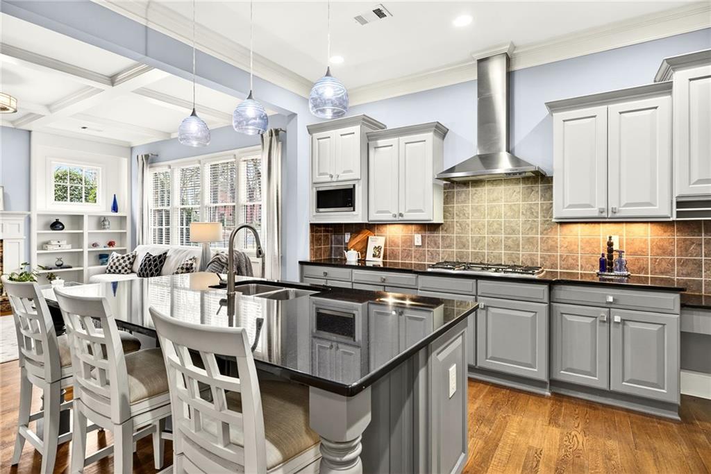 455 High Pointe Trail Roswell, GA 30076 - Photo 11 of 46 a kitchen with stainless steel appliances granite countertop a stove a sink dishwasher a refrigerator and white cabinets with wooden floor
