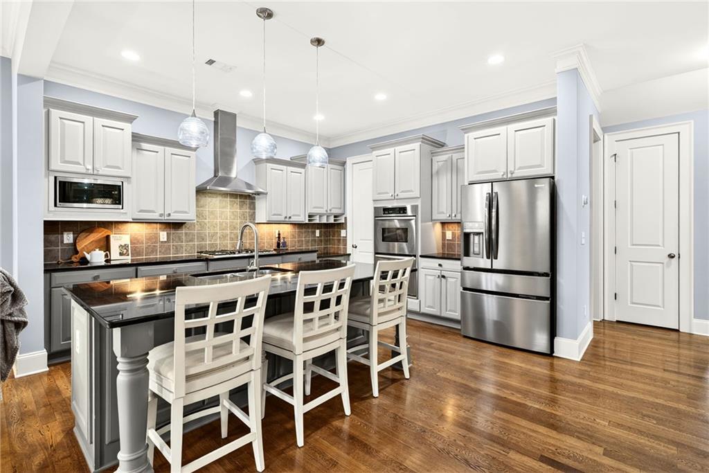 455 High Pointe Trail Roswell, GA 30076 - Photo 14 of 46 a kitchen with stainless steel appliances a refrigerator a stove a sink and white cabinets