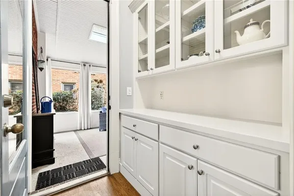 a bathroom with a granite countertop sink a mirror and shower
