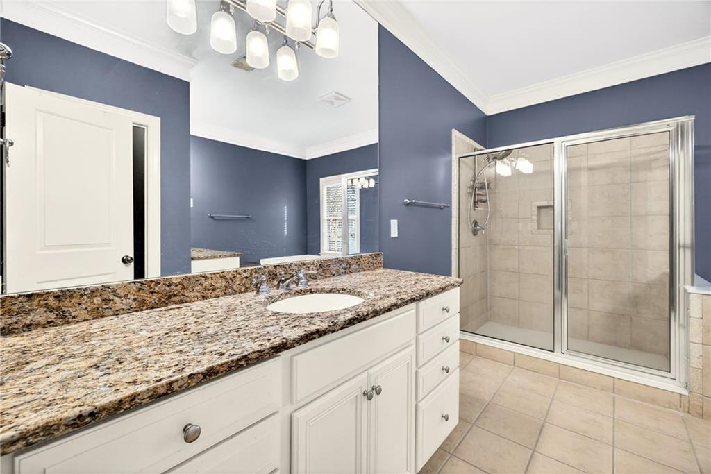 455 High Pointe Trail Roswell, GA 30076 - Photo 26 of 46 a bathroom with a granite countertop sink a mirror and shower